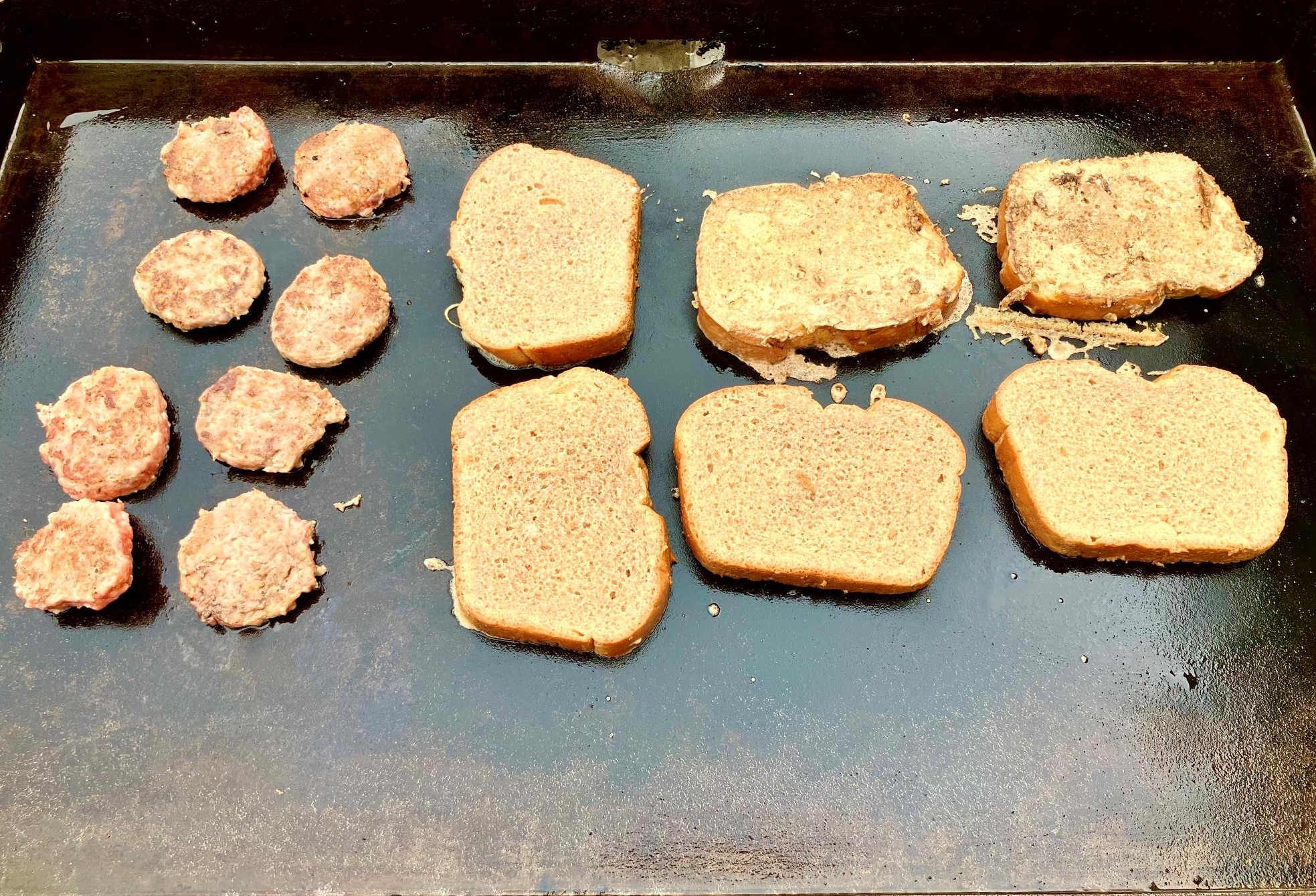 French toast and sausage cooking on the griddle