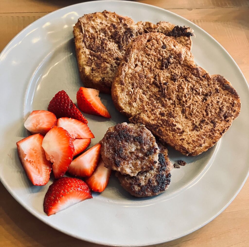 Plate with protein french toast, strawberries and sausage